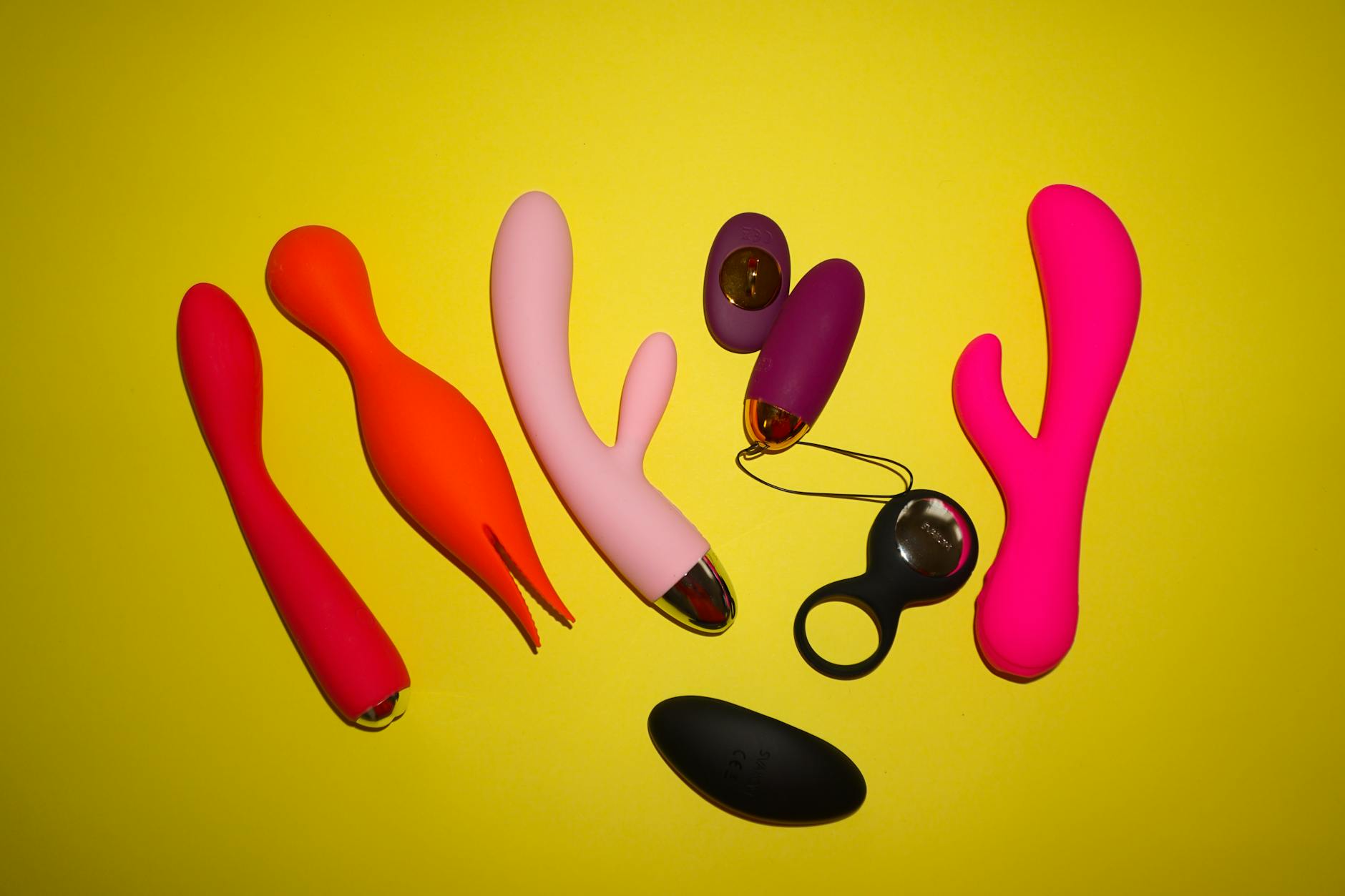 Woman holding a vibrator with intimate focus, emphasizing personal pleasure and connection