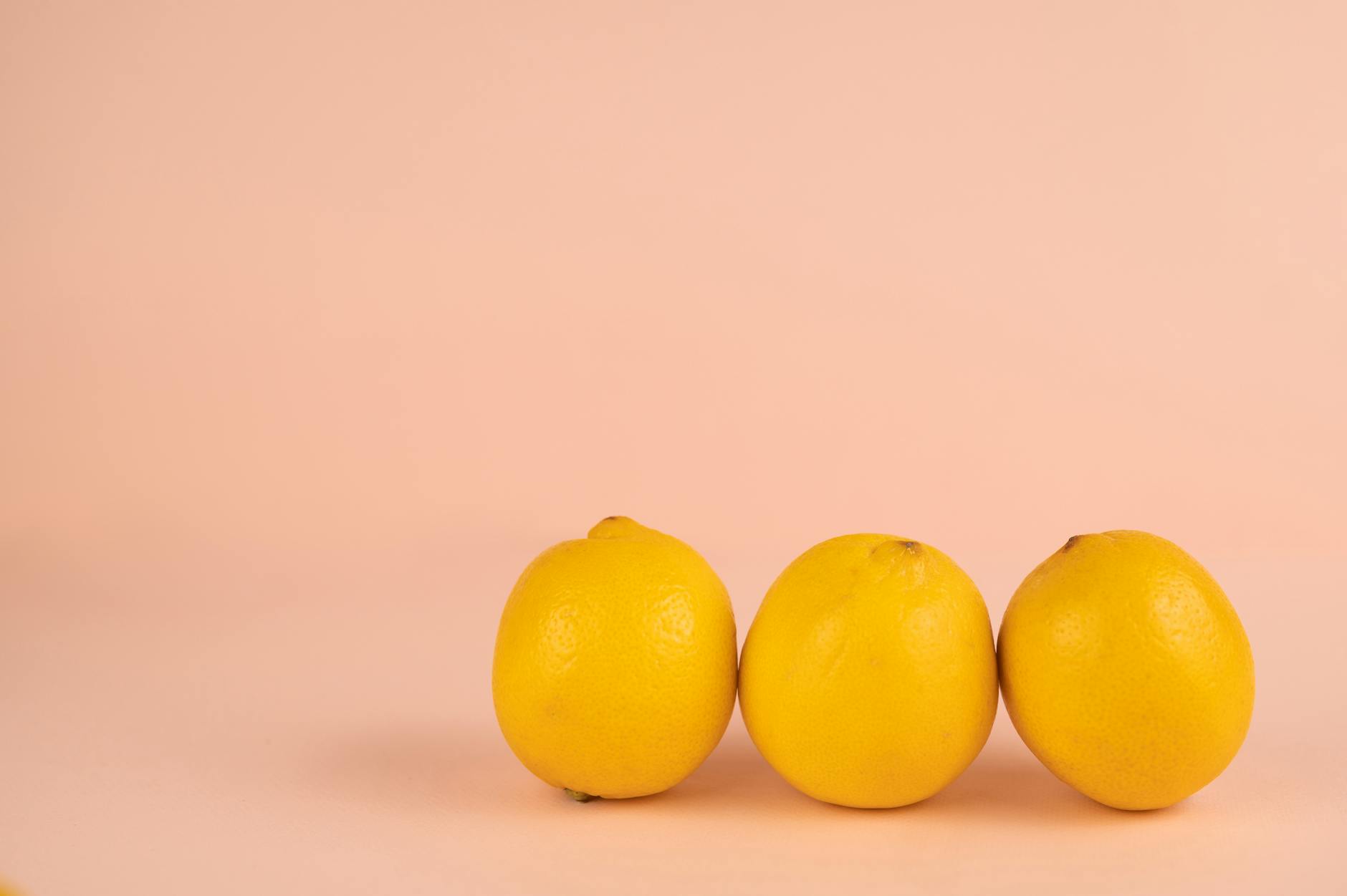 Bright yellow lemons on a soft pastel background symbolizing reconnection and sensation